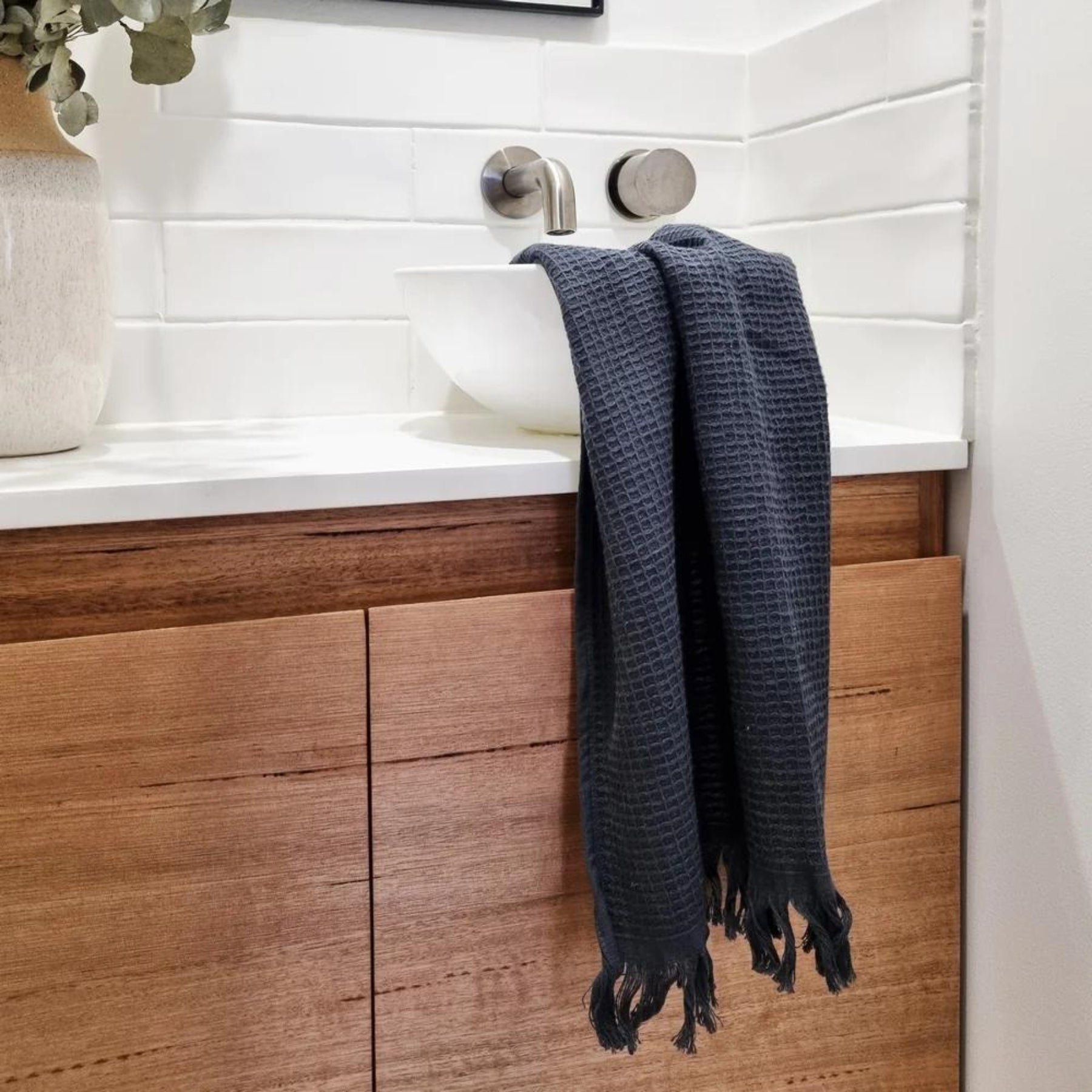 The Camila Set of 2 Hand Towels in a contemporary Coal colour, styled in bathroom setting