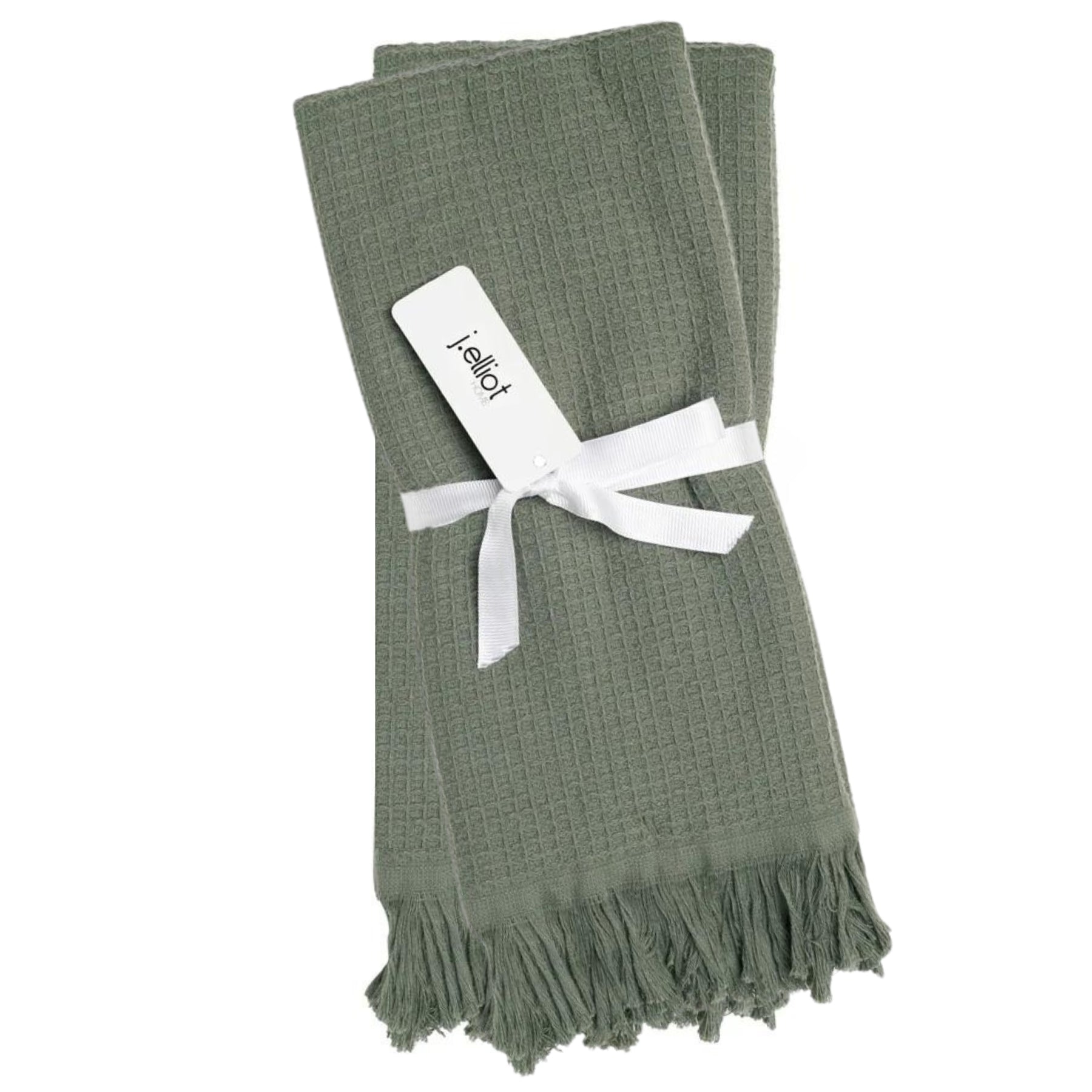 Neatly folded and tied with ribbon Camila Cotton Waffle Hand Towels in Chive, presenting a deep green hue and fringe detail for a natural, organic feel.