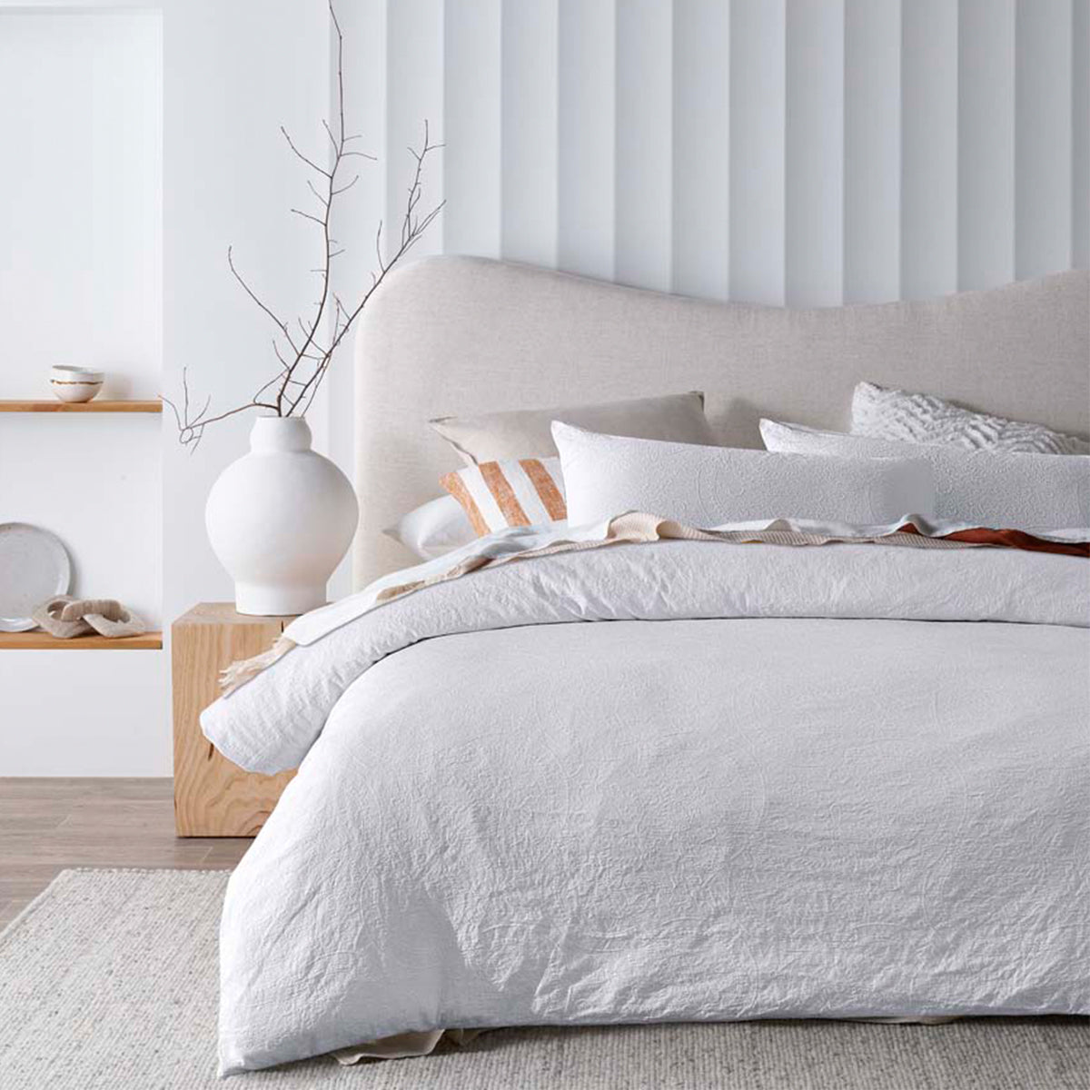 Estelle White Jacquard King Quilt Cover Set in a well-lit bedroom setting, showcasing the elegant texture and cosy ambiance