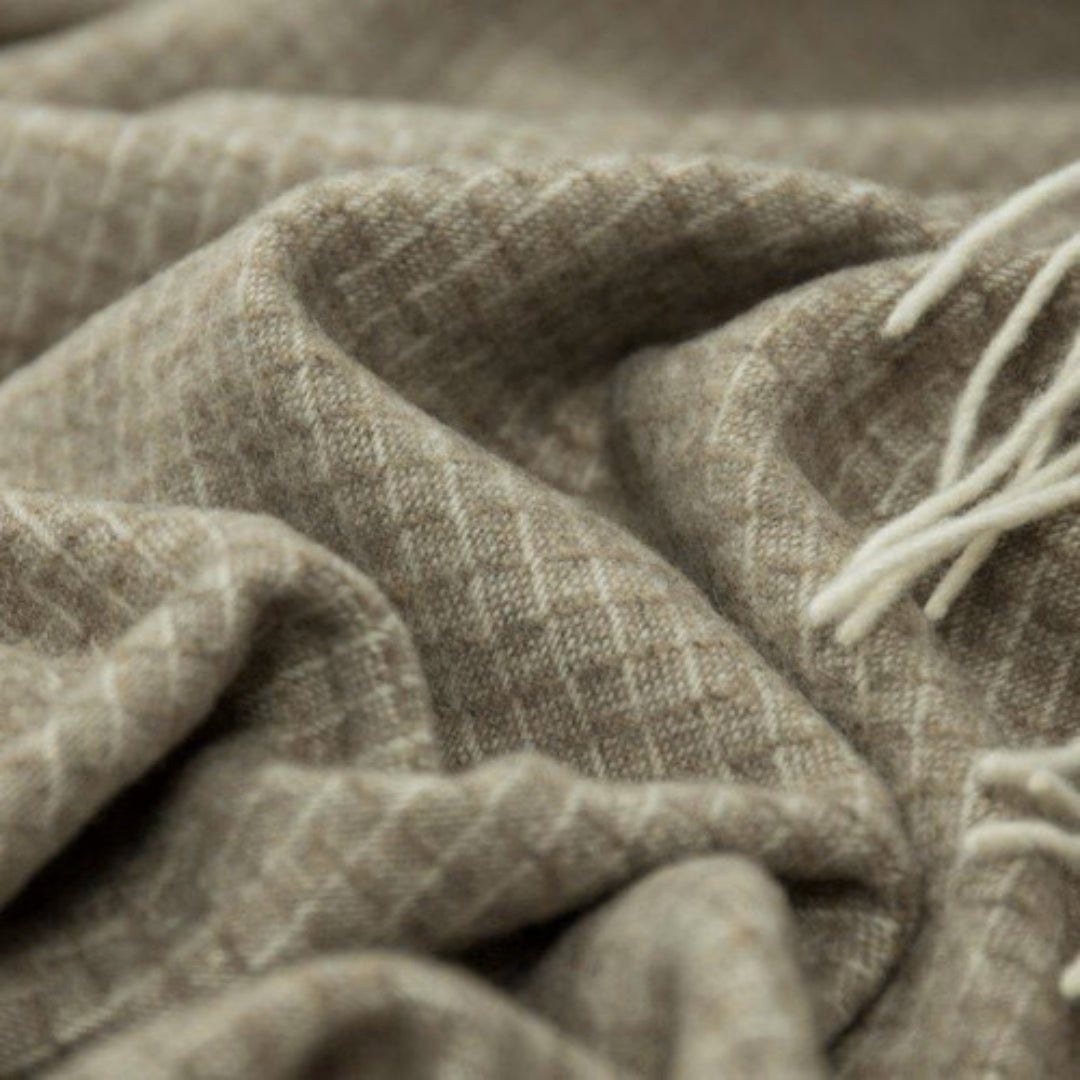 Close-up view of the Chiswick Beige Merino Wool and Cashmere Throw showcasing its detailed weave and plush texture.