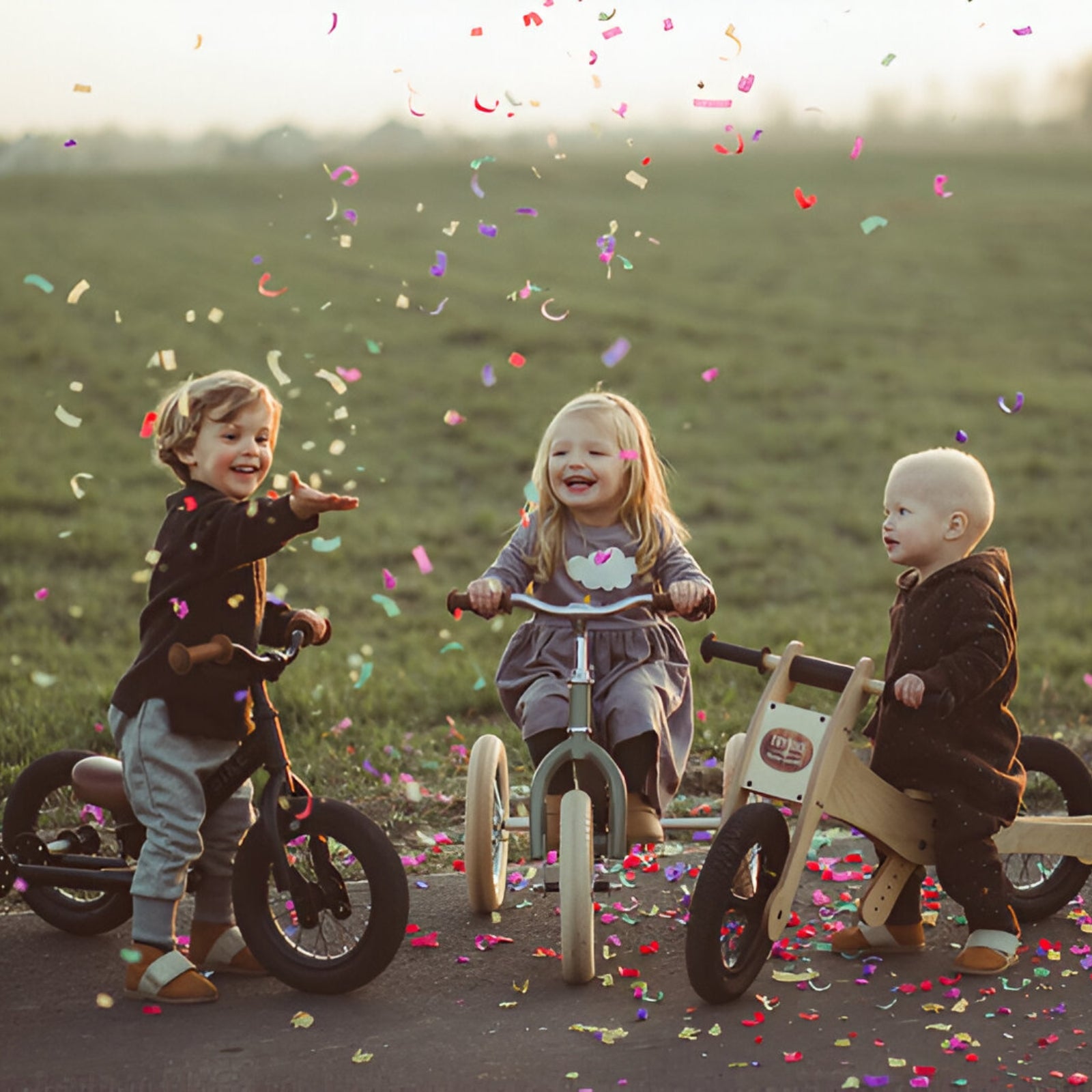 Joyful moments with Trybike Black as children celebrate with colorful confetti.
