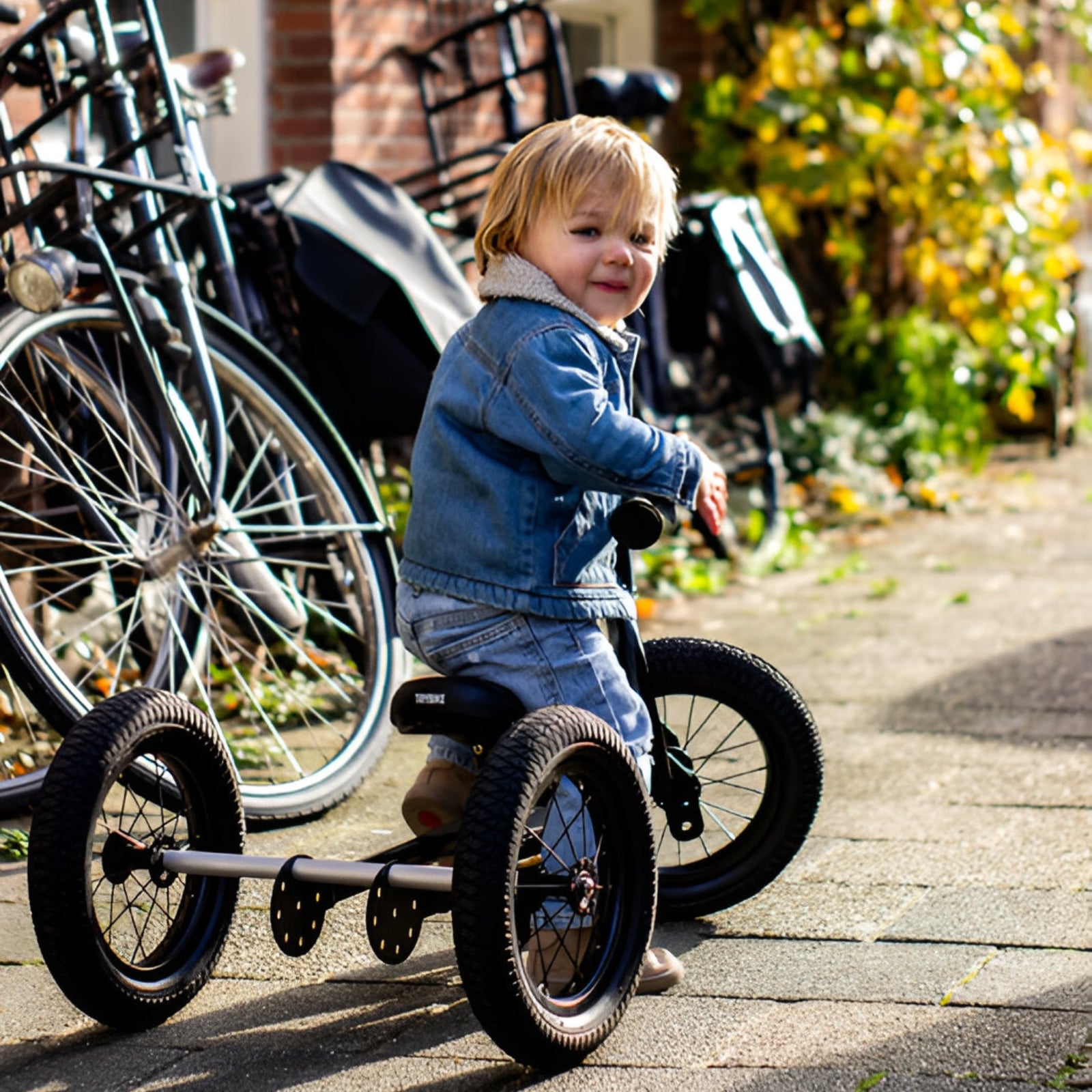 Child enjoying a sunny day out with the Trybike Black.