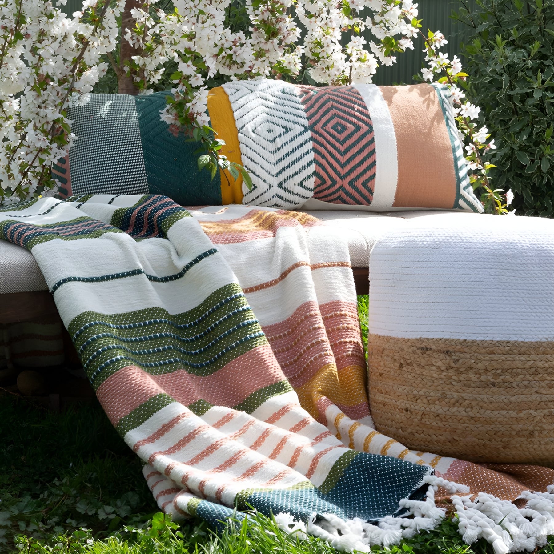 Zephyr Throw Blanket in outdoor setting, showcasing Peach Hues and versatile use.