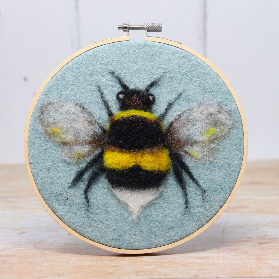 Bee in a hoop needle felt kit completed bee in timber hoop sitting on side