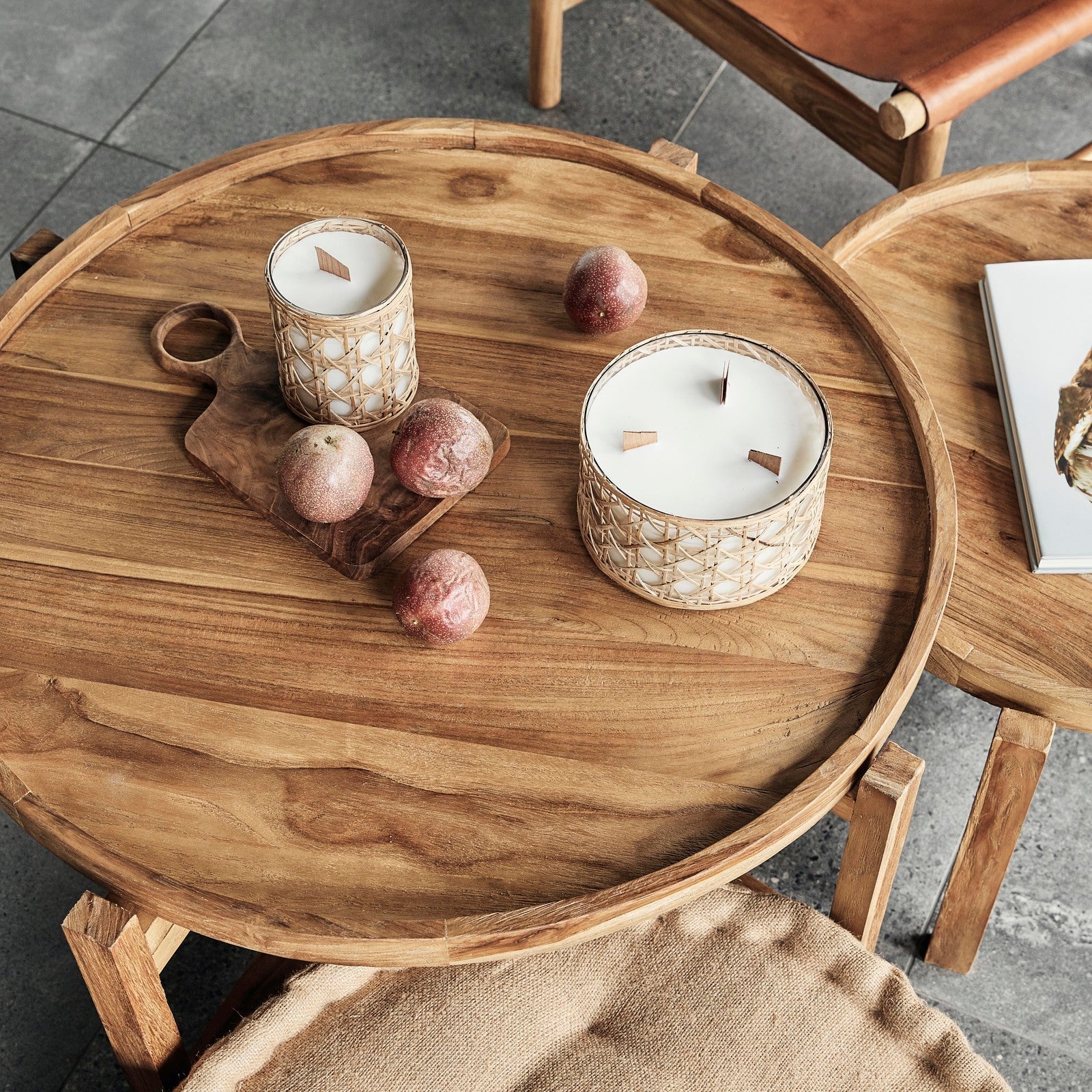 cyrus round coffee table large and small styled together with candles and passionfruit scattered on top